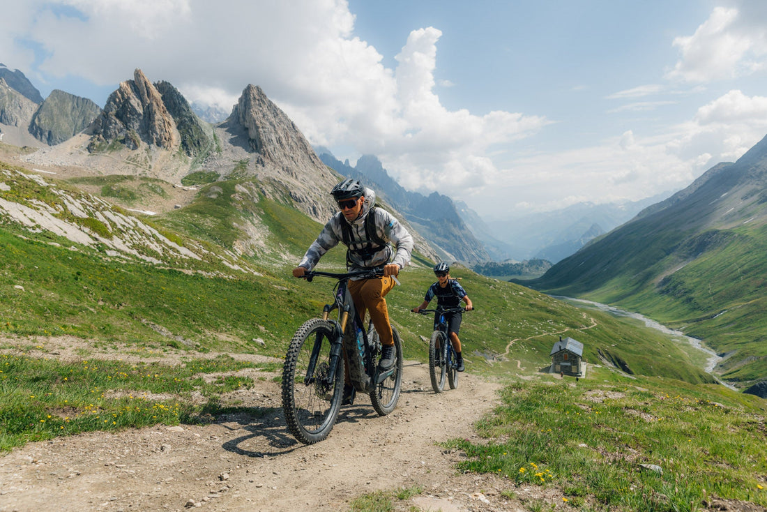 Couple riding e-bikes in the Italian Alps