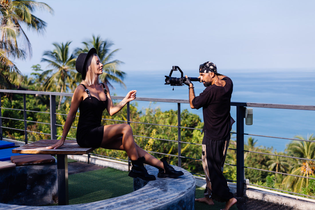 A female influencer is modeling while being filmed on tropical balcony in Bali